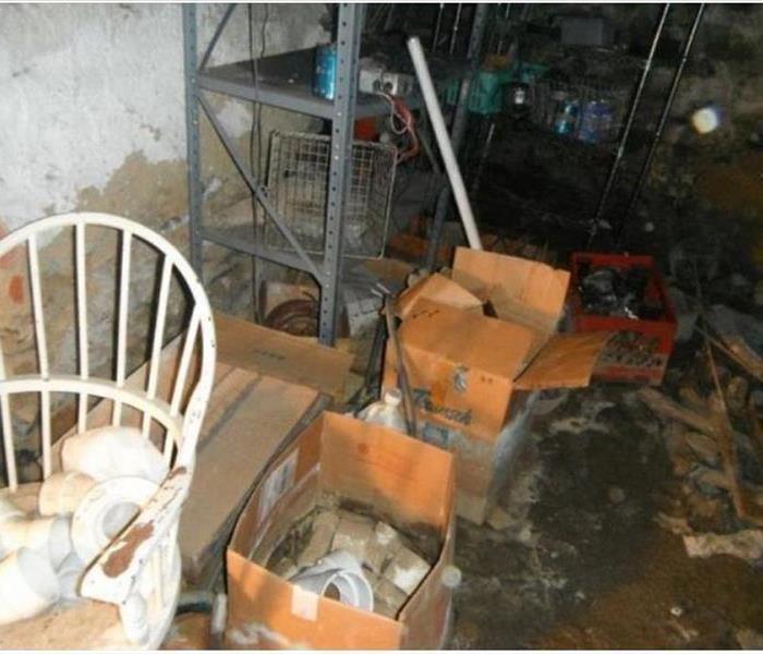 water damage in basement and belongings of the owner including boxes chair and other belongings