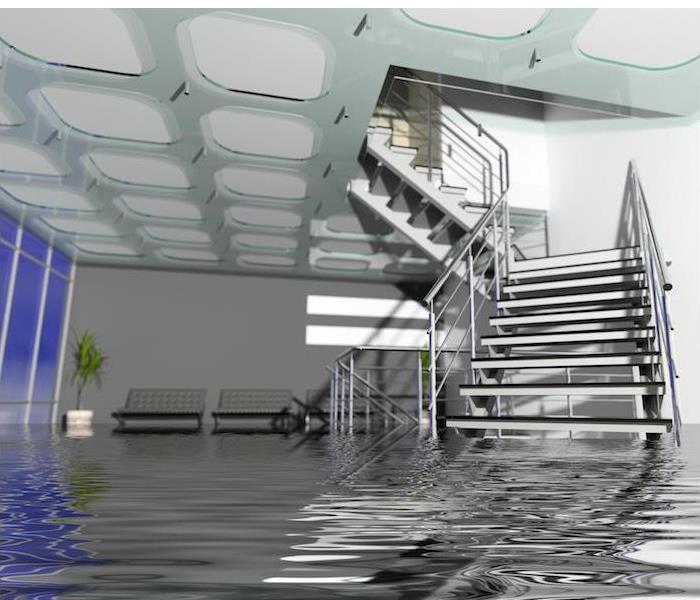 Flooding in large room with staircase partially submerged in water